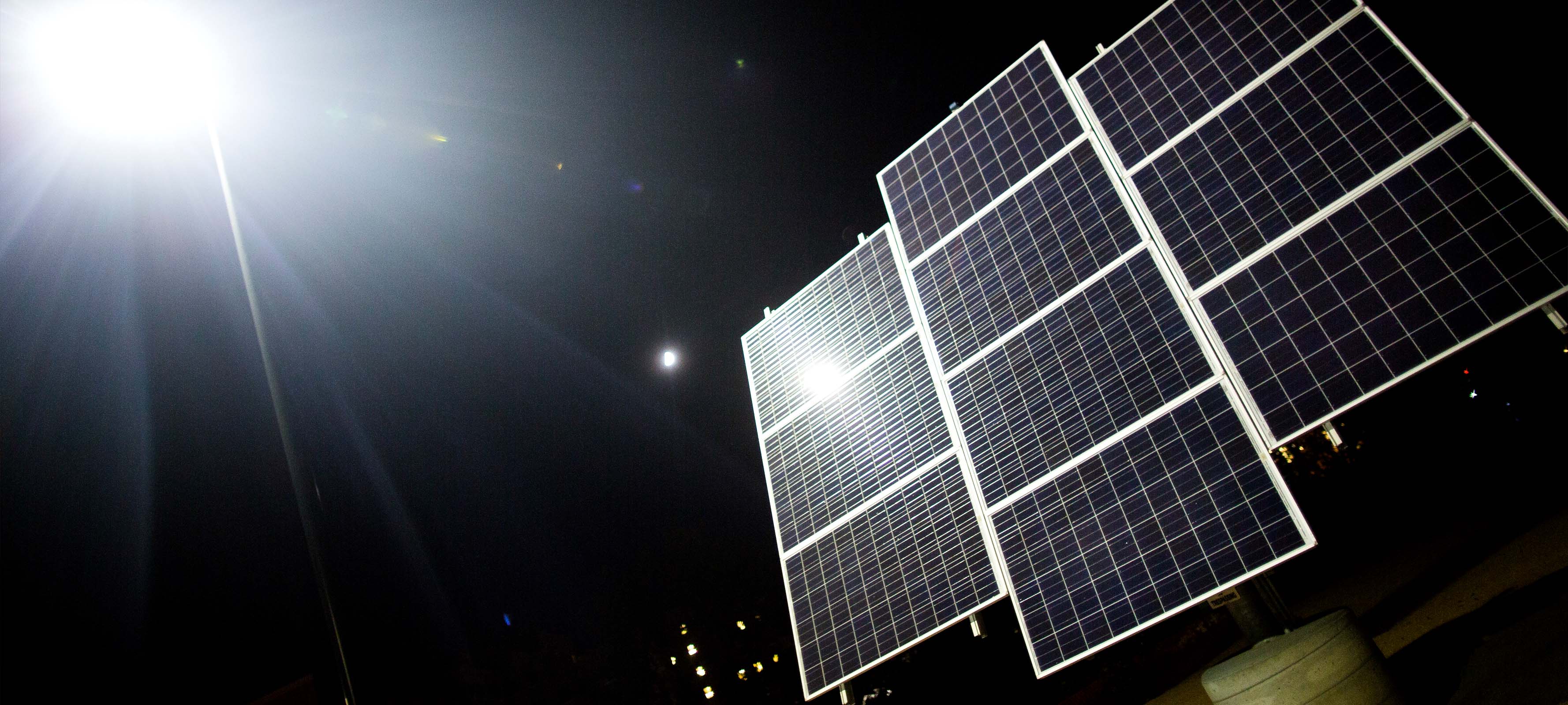 A solar panel illuminated at night.