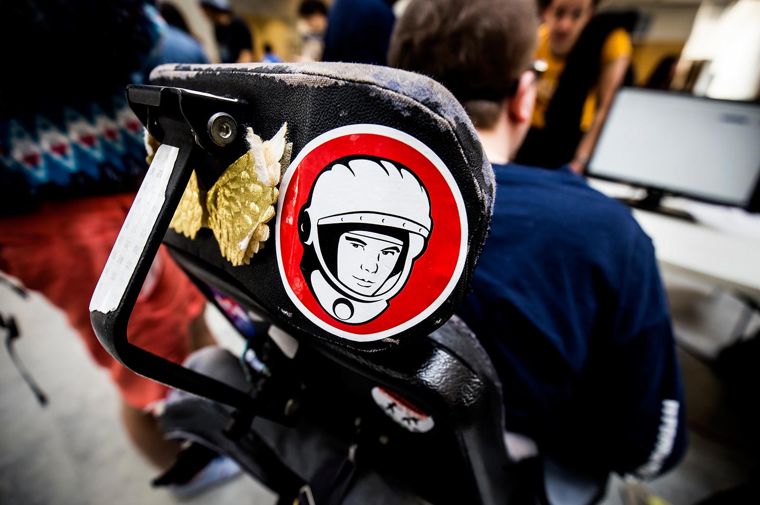 An astronaut sticker adorns the back of a disabled student's wheelchair