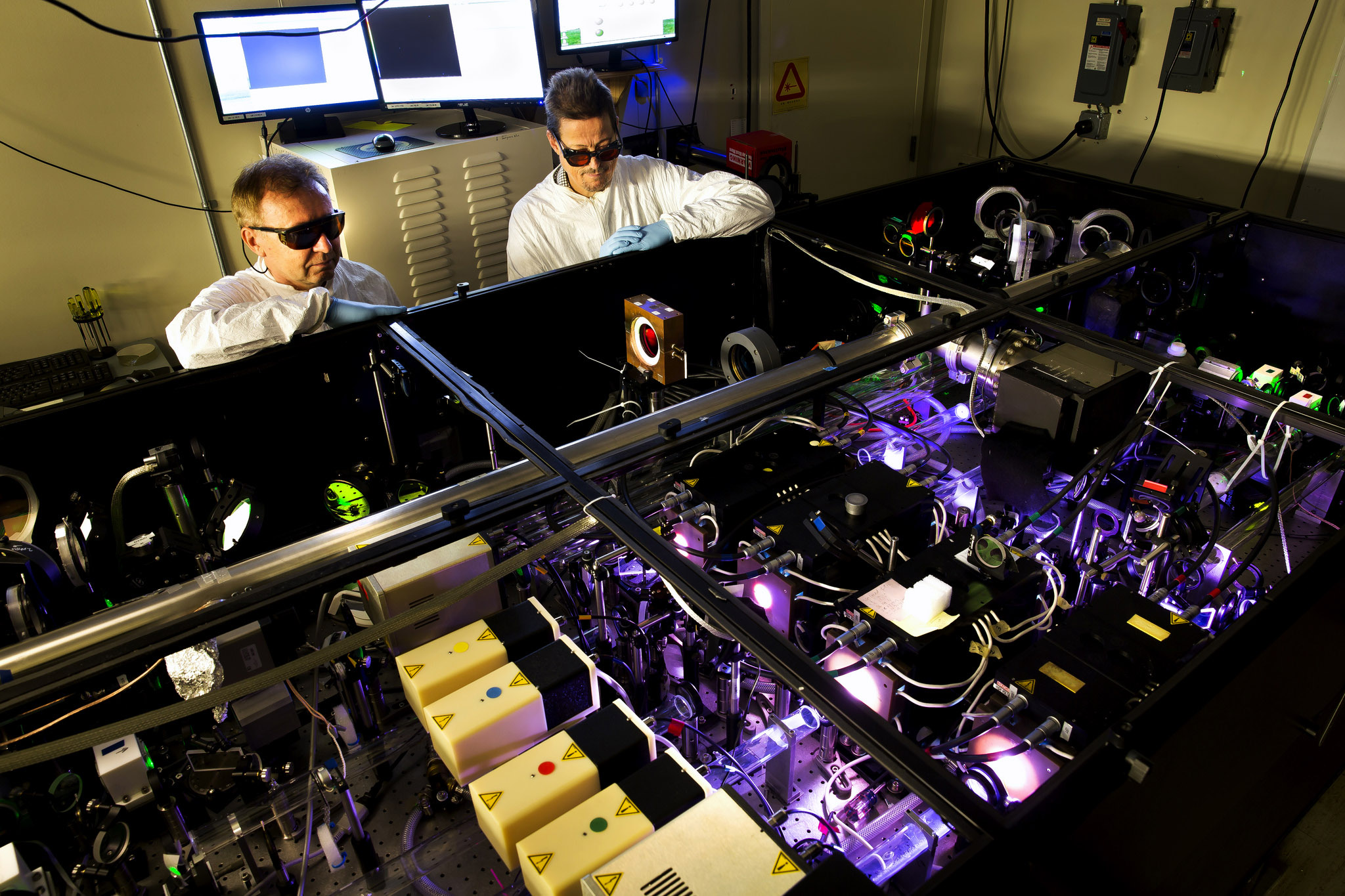 A photograph of researchers testing a laser in lab.