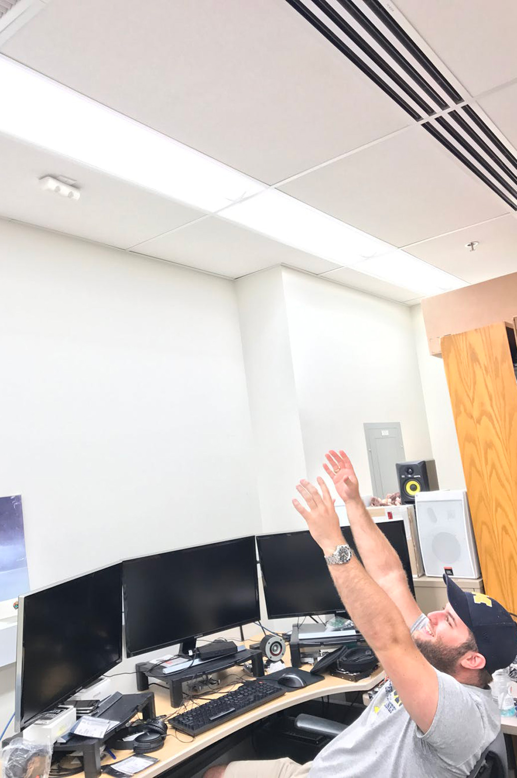 Student raises his arms in a classroom