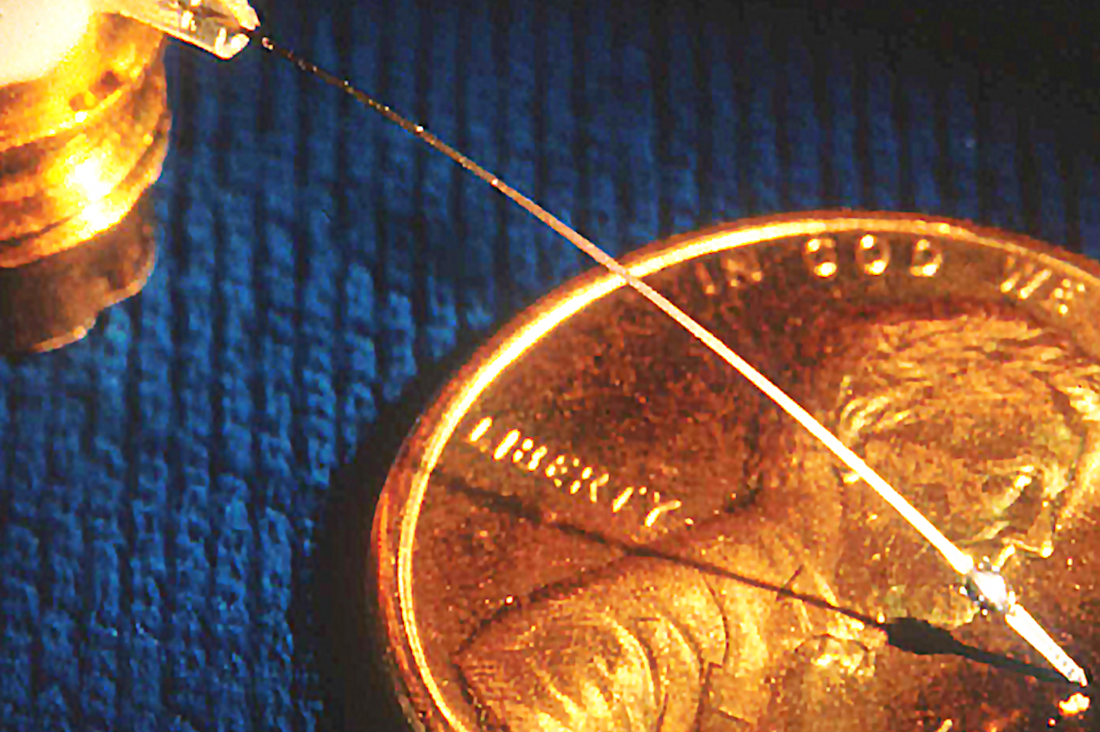 close-up of probe crystal with a U.S. penny