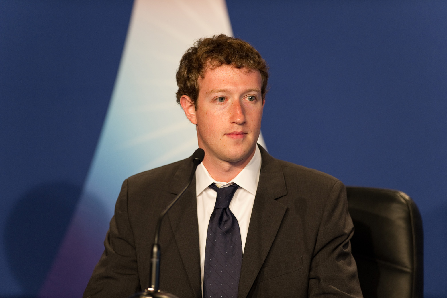 Facebook CEO Mark Zuckerberg seated at a table