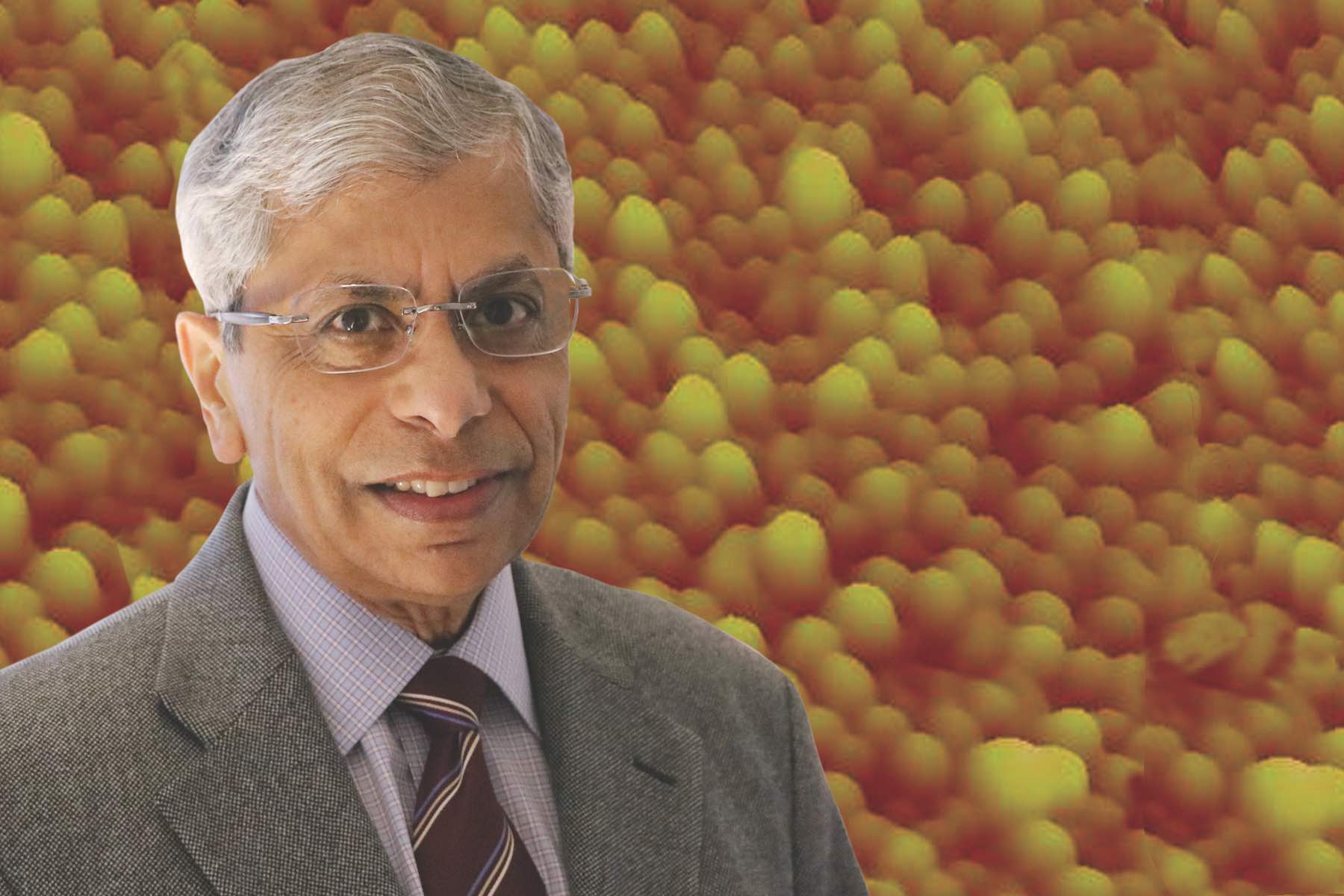 Prof. Pallab Bhattacharya with a background of quantum dots for red-emitting diode lasers.