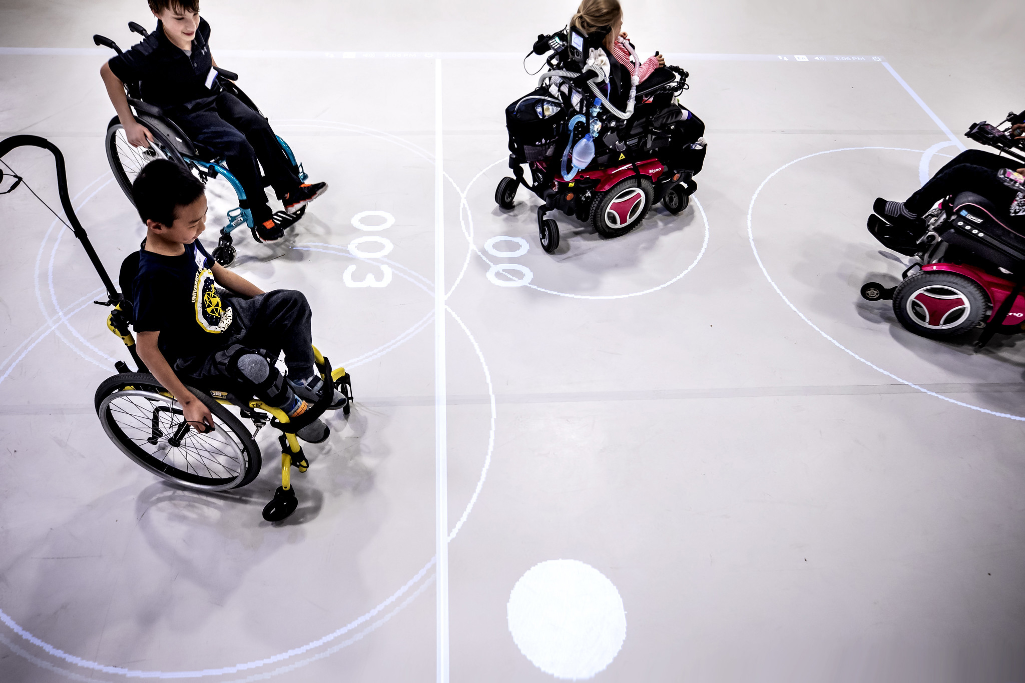 A photograph of children in wheelchairs playing an augmented reality game.