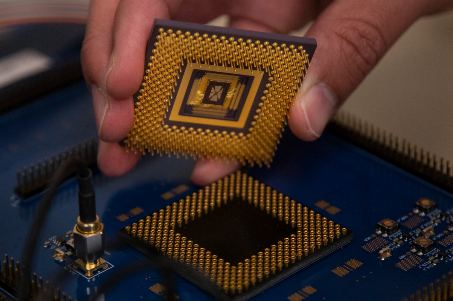 The memristor array chip plugs into the custom computer chip, forming the first programmable memristor computer. The team demonstrated that it could run three standard types of machine learning algorithms. Photo: Robert Coelius, Michigan Engineering Communications & Marketing