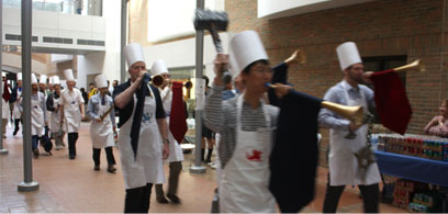 Faculty marching into EECS with Chef's hats