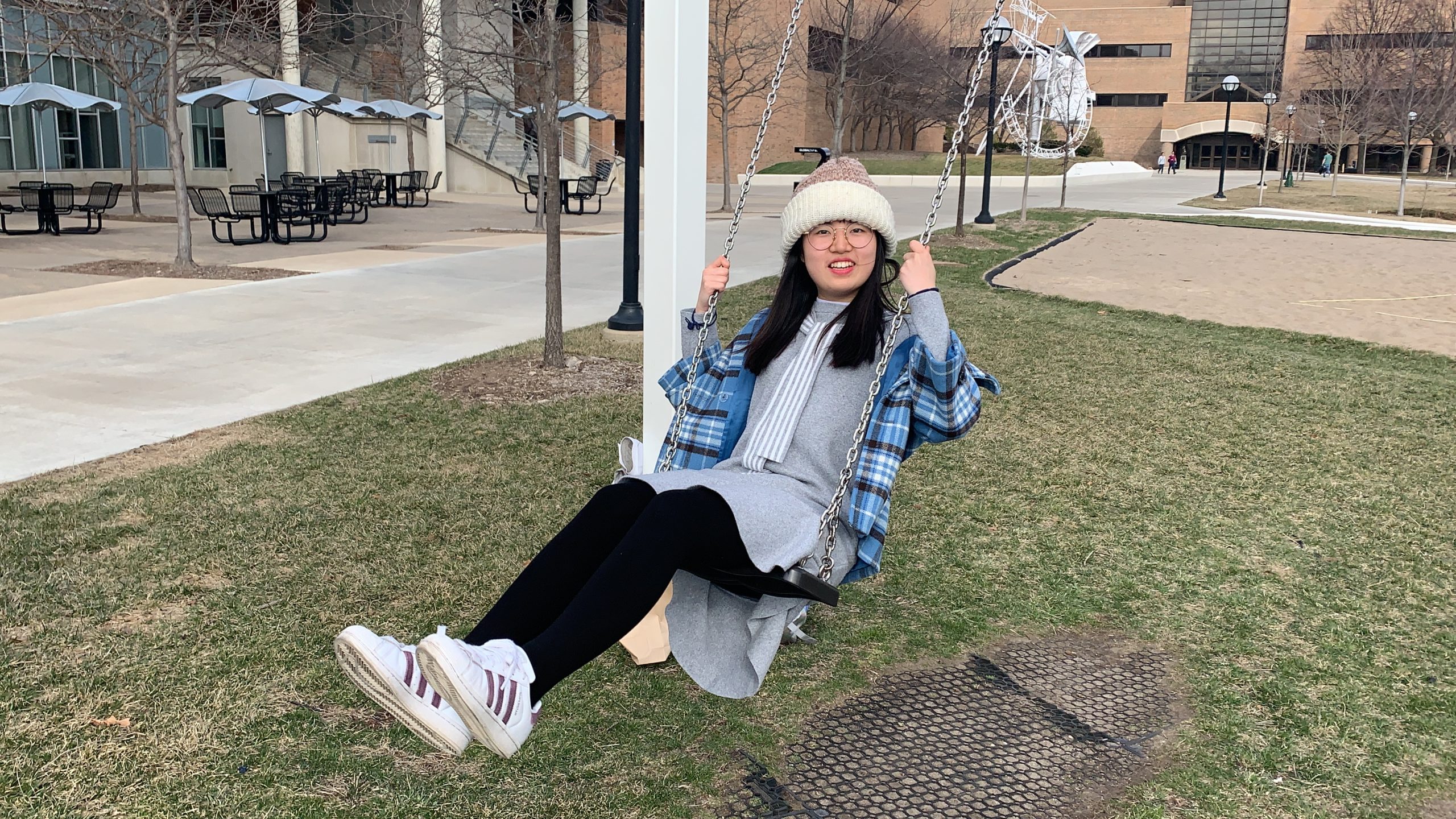 Jiayi Chen on a swing on North Campus