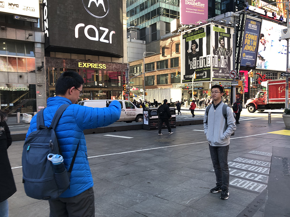 Students take photos in Times Square
