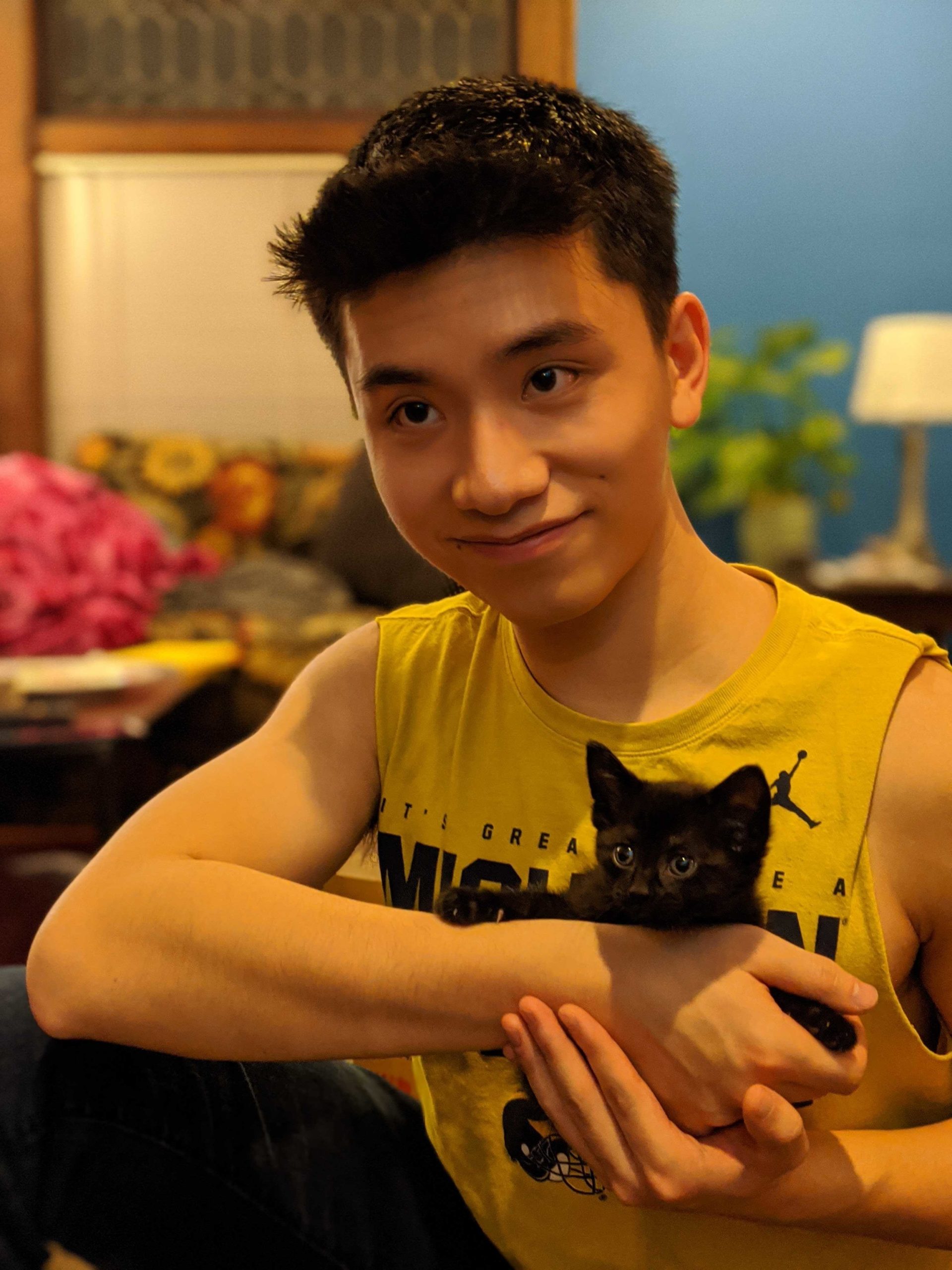 Derek Chen with a kitten