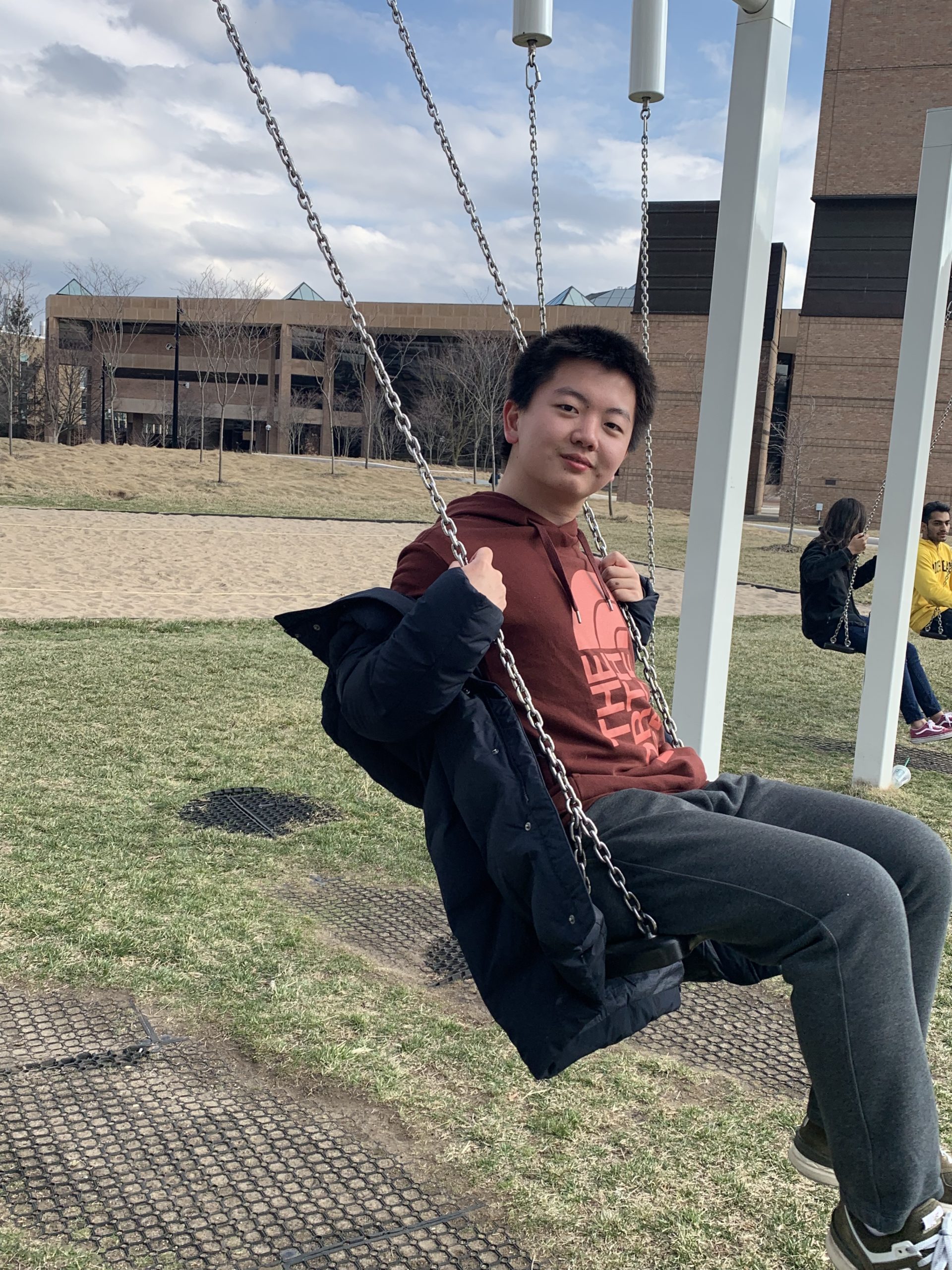 Ruiqi on a swing on North Campus