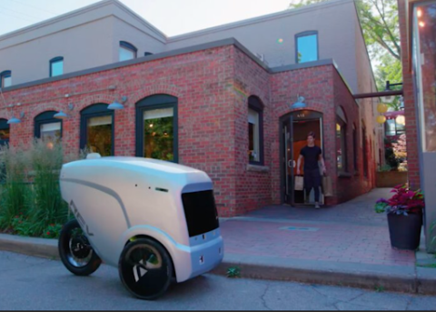 Robo delivery vehicle outside business