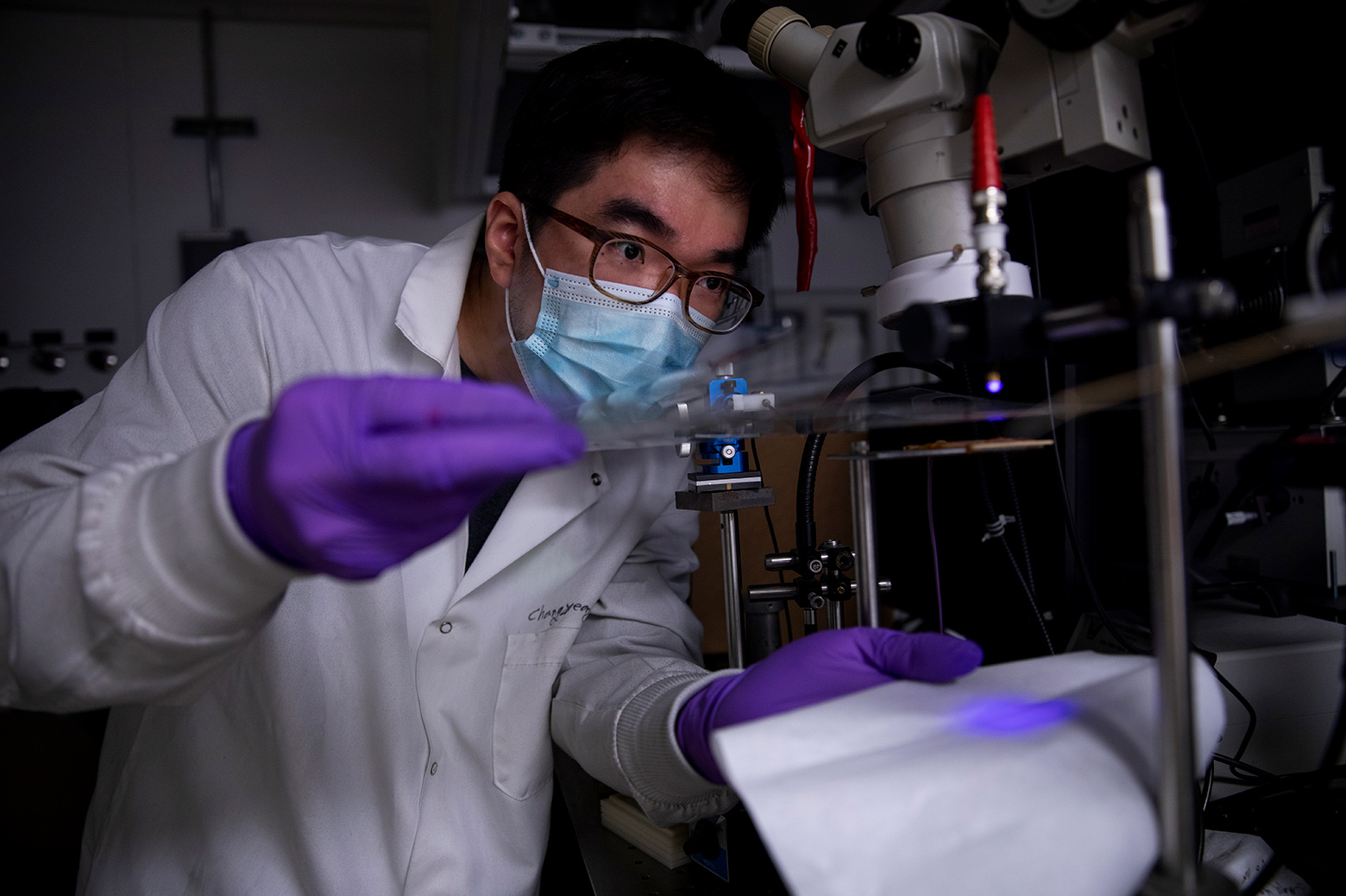 Changyeong Jeong, a graduate student in electrical engineering and computer science, measures how well light passes through a sheet of flexible transparent conductor. The material sandwiches a thin layer of silver between two “dielectric” materials, aluminum oxide and zinc oxide, producing a conductive anti-reflection coating on the sheet of plastic.