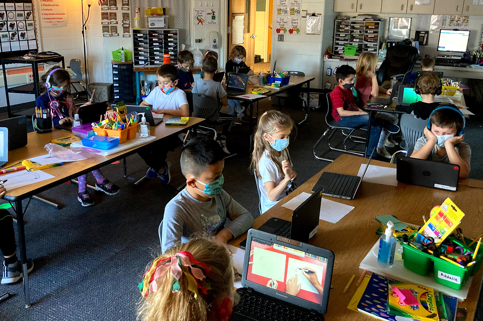 Kids learning in the classroom with laptops