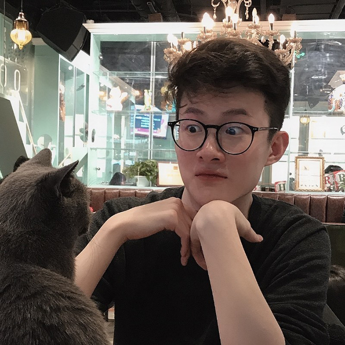 Sky Wang has a staring contest with a grey cat, who is clearly winning