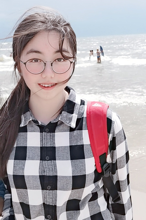 Yongle Liu selfie with beach in background