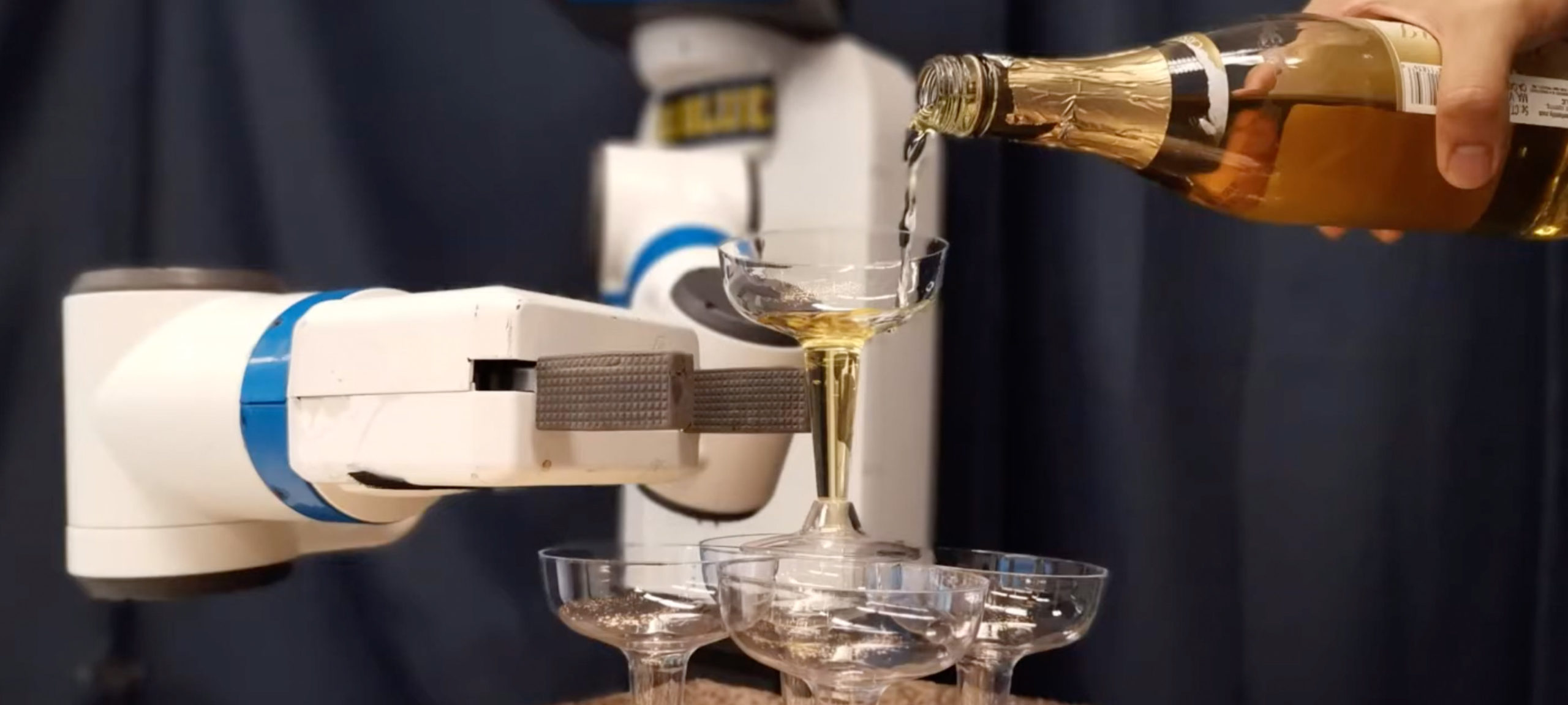 Robot building a tower of champagne glasses