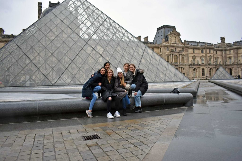 Caroline Nguyen and friends in front of Louvre pyramid