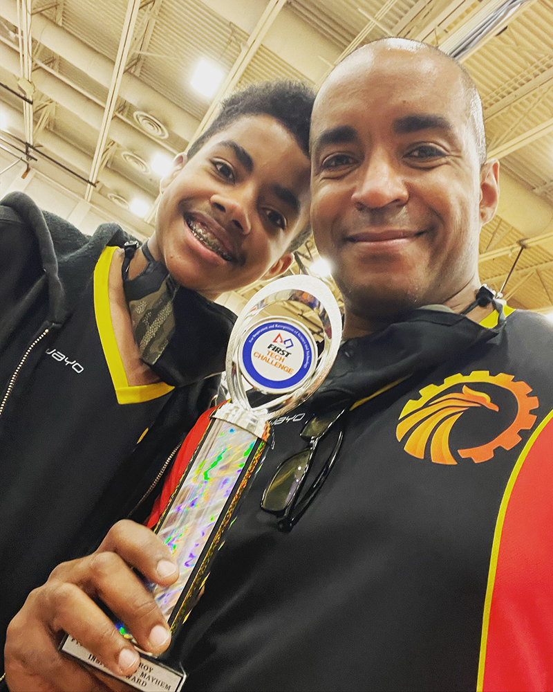 Leon Pryor and his son holding a trophy