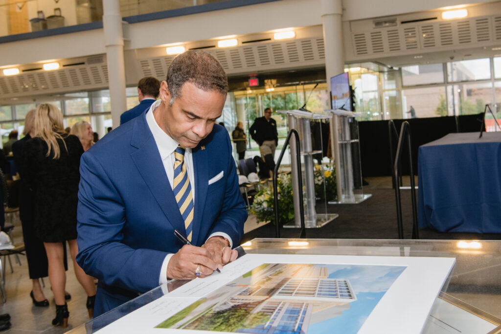 Dean Gallimore signs a rendering of the building.