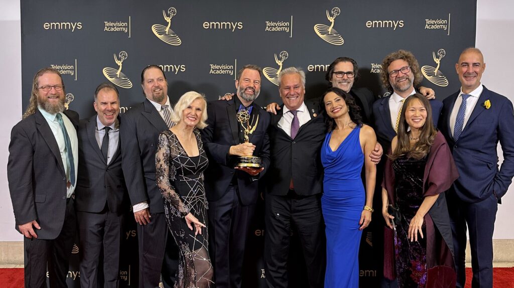 Paul Debevec holding his Emmy with hsis friends
