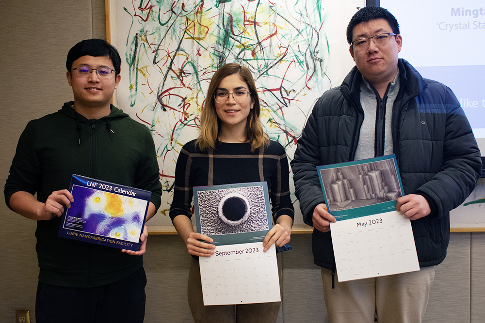 Mingtao Hu, Behnoush Rostami, and Jiangnan Liu holding the calender with their photo 