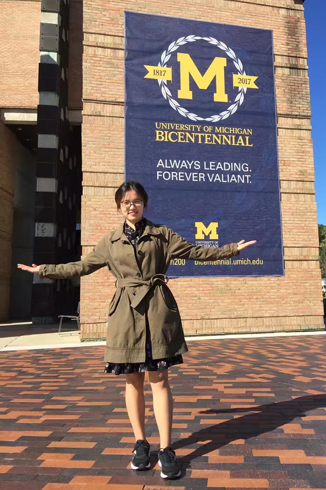 Kai Cui in front of the Lurie Bell Tower on North Campus