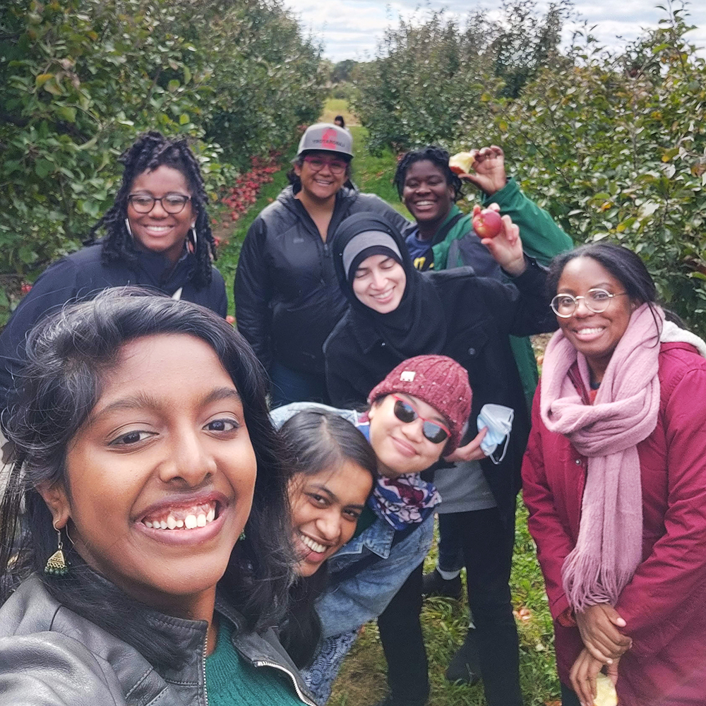 Diverse group of women smiling in the apple orchard