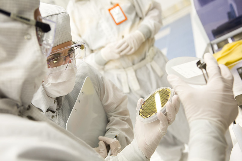 Researchers examining plates inside the Lurie Nanofabrication Facility. Photo: Joseph Xu/Michigan Engineering