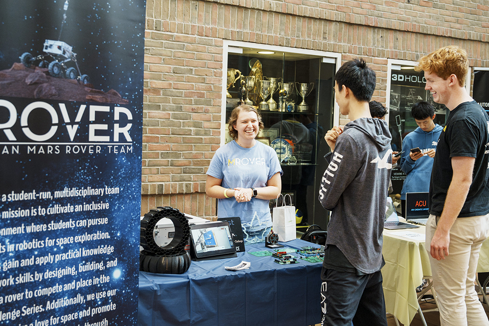 attendees chat with the student representatives for MRover