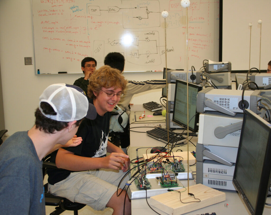 Students in a lab with communications equipment