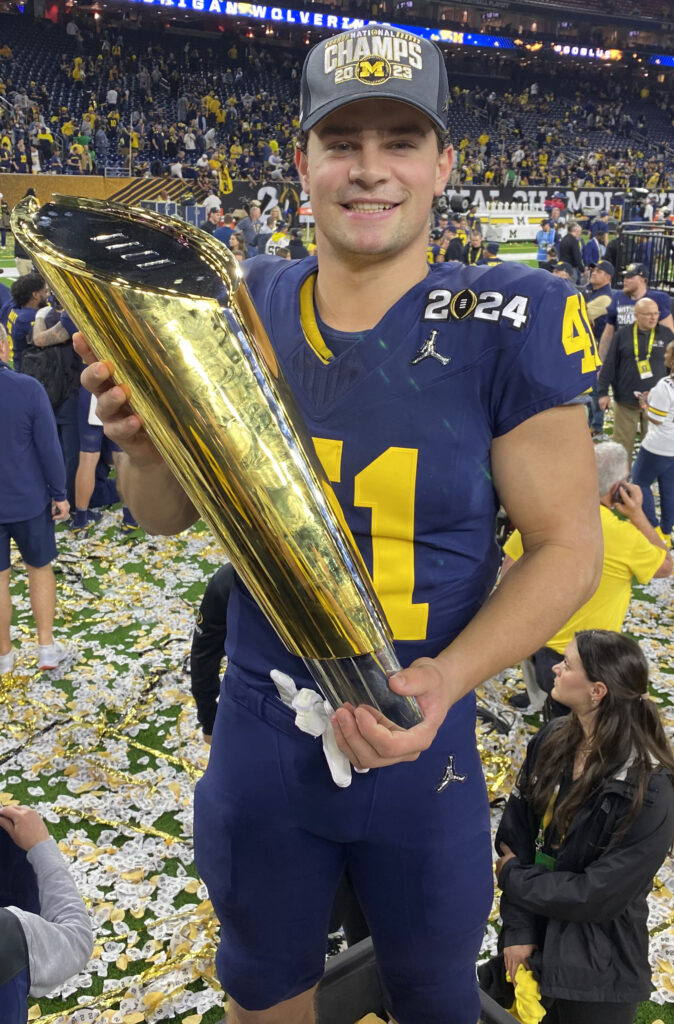 photo of Joshua Luther holding trophy