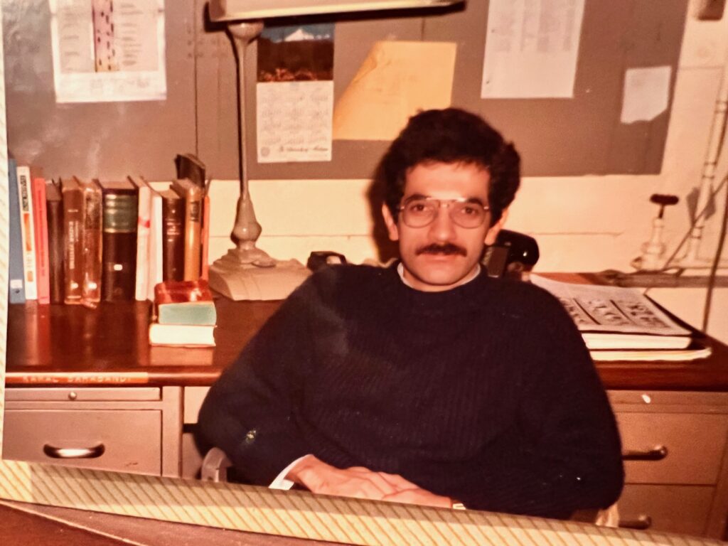 Kamal Sarabandi as a graduate student, sitting at a desk.