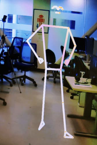 A white stick-figure outline of a person in a computer lab