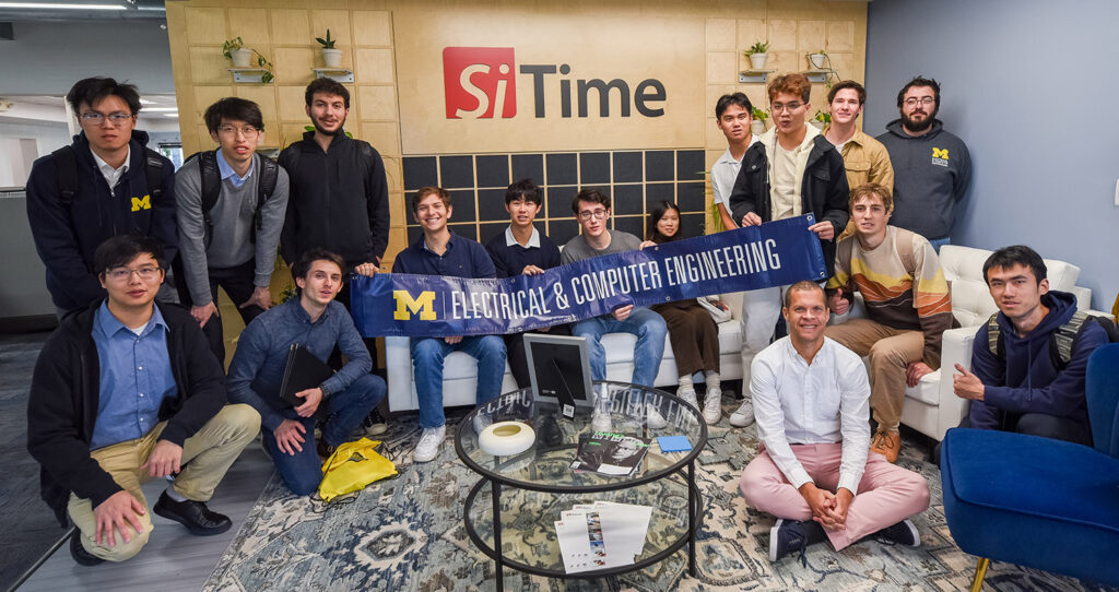 Students holding ECE signs at Si Time