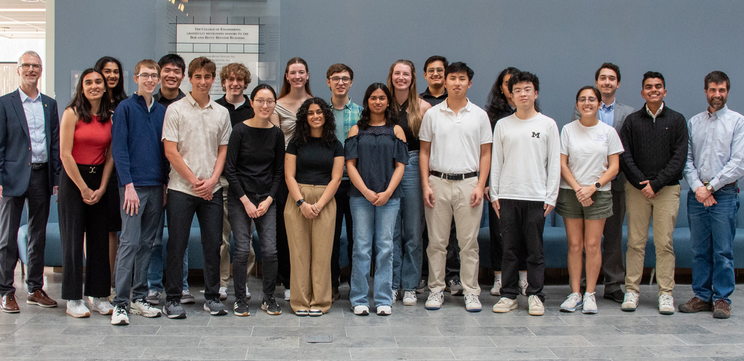 group photo of students with two administration officials