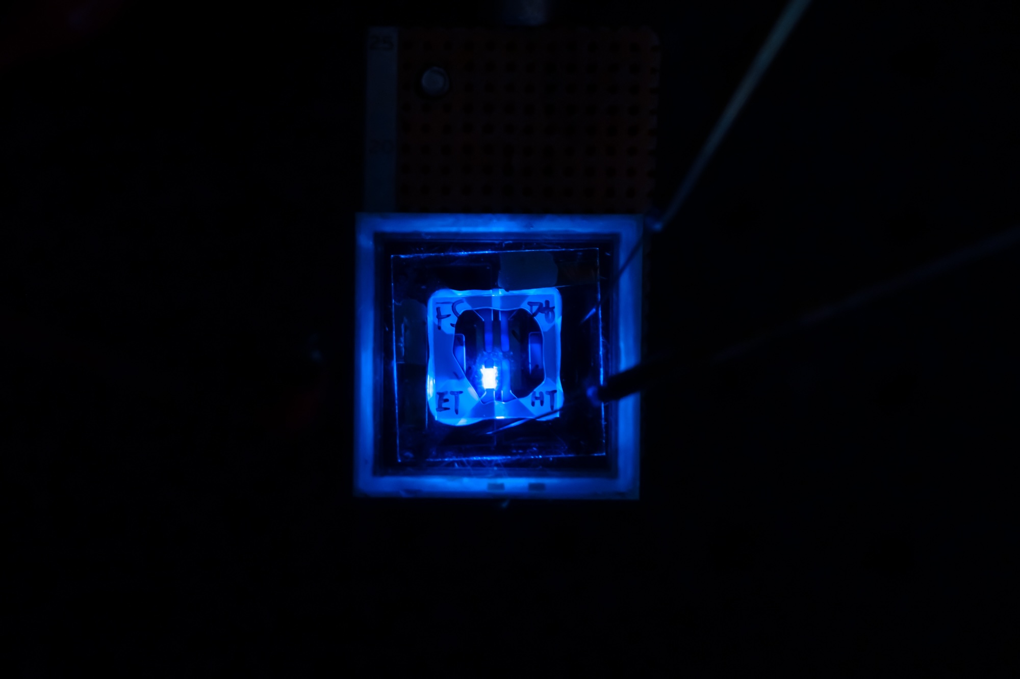 A rectangular blue light shines from a transparent square, its edges marked out by the glow