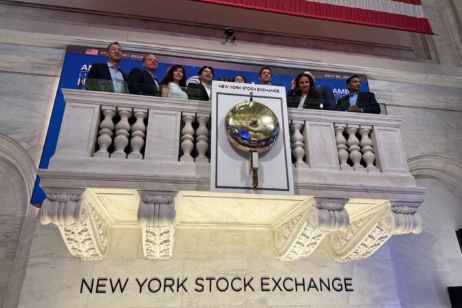 New York Stock Exchange bell with Ambiq executives and investors standing behind the bell.
